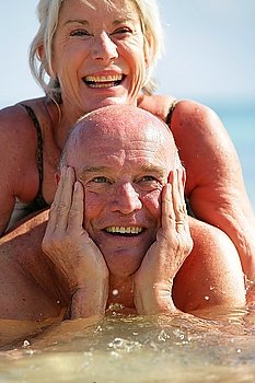 senior couple swimming in the sea