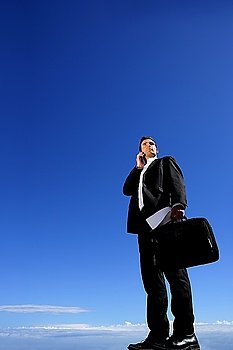 Businessman with briefcase and mobile