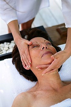 Woman having her face massaged