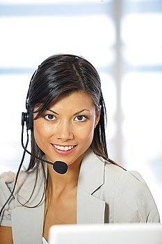 Portrait of a happy secretary wearing a headset