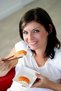 Brunette eating delicious shushi