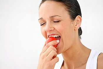 Brunette taking a bite out of an apple