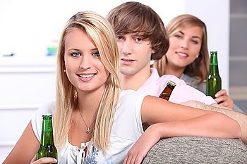 Three teenagers drinking beer