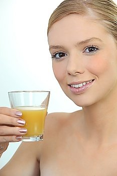 Woman drinking a glass of orange juice