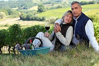 Couple drinking wine in a vineyard
