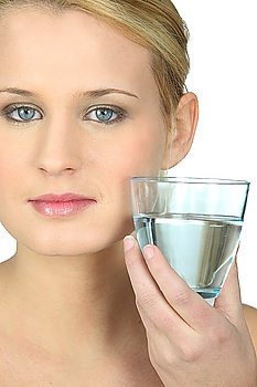 Blond woman with glass of water in hand