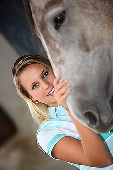 Girl in stable with horse