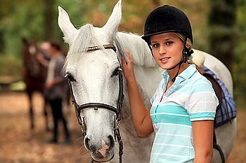 Girl stroking white horse