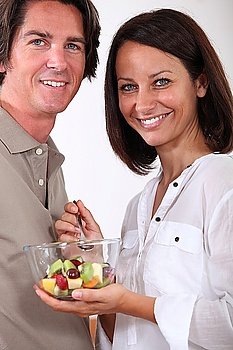 A couple sharing a salad.