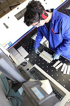 Man operating cutting machine in workshop