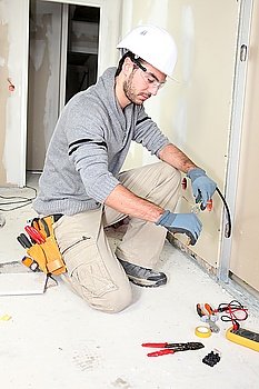 Electrician wiring a house