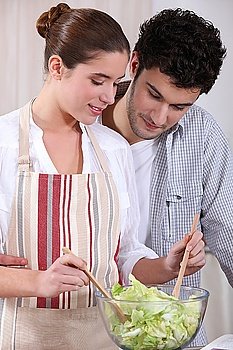 Husband and wife preparing salad
