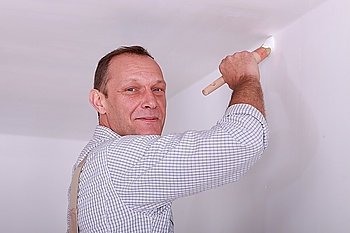 Painter painting wall