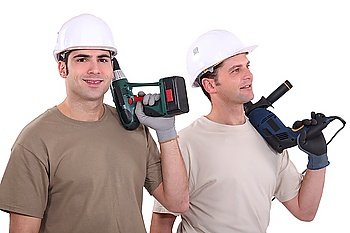 Two male builder with drills