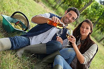 Couple with wine in the field