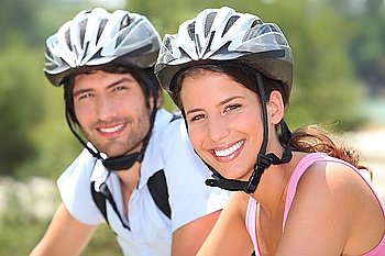 Couple with bicycle helmet