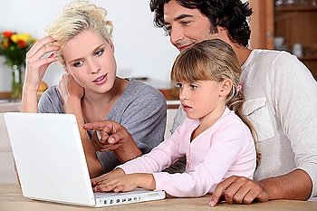 Parents with daughter with computer
