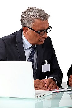 Senior businessman attentively listening to colleague
