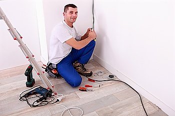 Tradesman installing electrical wiring