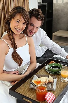 Couple with breakfast in bed