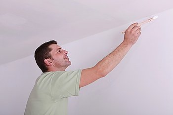 Painter painting a ceiling corner