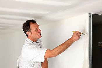 Man painting final touches to wall
