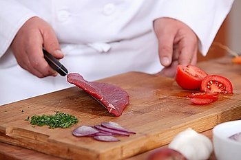 Male hands preparing steak