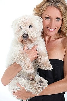 Middle-aged woman with dog in arms.