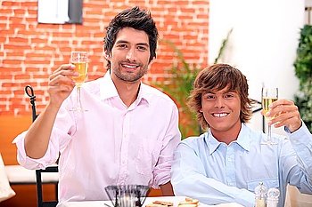 homosexual couple celebrating event at restaurant