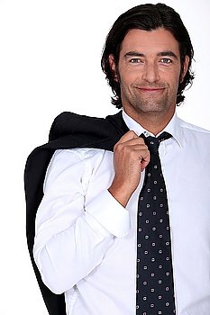 Smiling businessman with his jacket over his shoulder