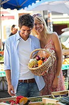 Couple with a basket at market