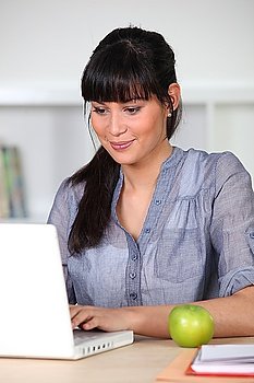 Woman with computer and apple