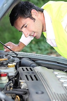 Man looking at a car engine