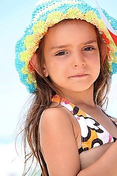 Young girl in a bikini and sunhat