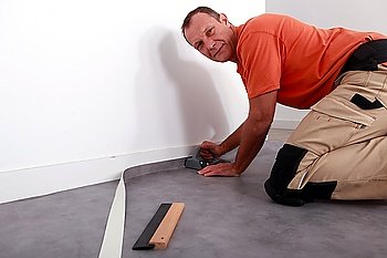 Man cutting carpet