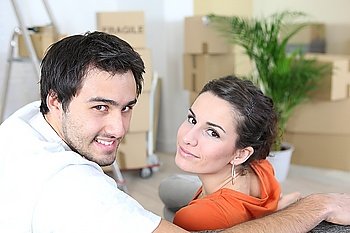 Couple surrounded by packing boxes