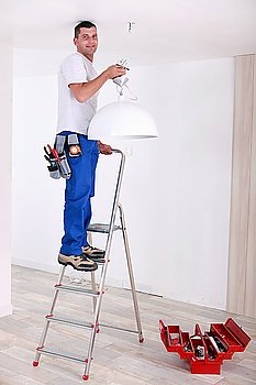 Handyman fixing lighting