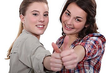 Two teenage girls giving the thumbs-up