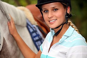 A horseback rider with her horse