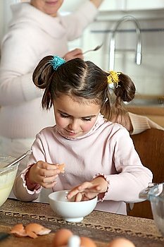 Little girl preparing eggs