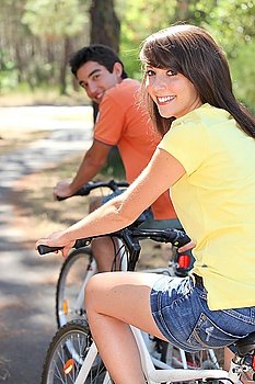 Young couple enjoying bike ride together