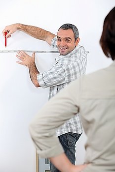 husband taking measurements in the house