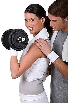 Young couple exercising with a dumbbell