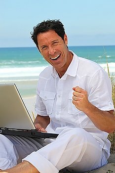 Man happy working on the beach.