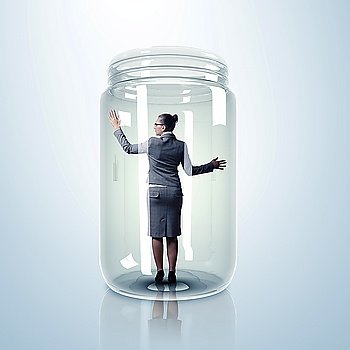 Businesswoman trapped inside a transparent glass jar