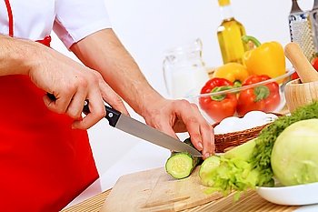 Fresh vegetables being cut with a knife