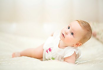one years old baby girl on a light background