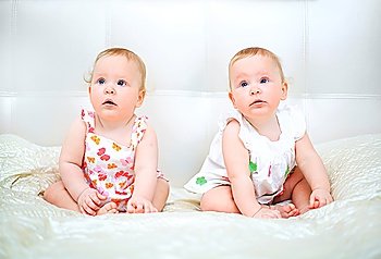 one years old baby girls on a light background