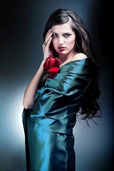attractive woman in green fabric with red rose