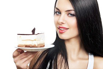 attractive woman with cake on white background